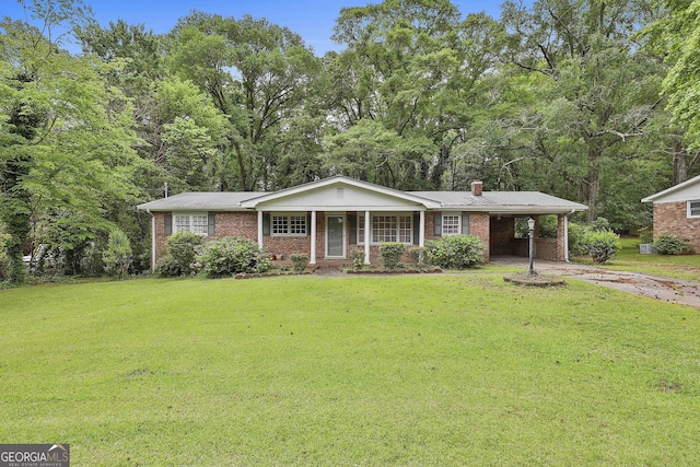 single story home featuring brick siding, a front lawn, a chimney, and concrete driveway