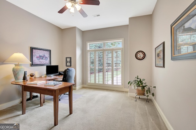 home office with baseboards, visible vents, light carpet, and ceiling fan