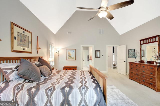 bedroom with light colored carpet, high vaulted ceiling, visible vents, and ensuite bath