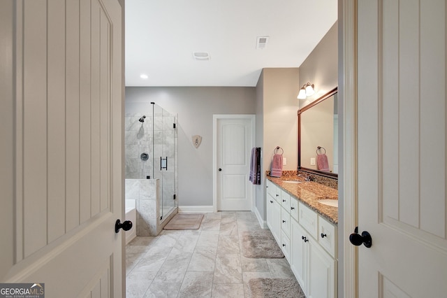 full bath with a sink, double vanity, baseboards, visible vents, and a stall shower