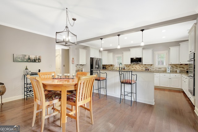 dining area featuring crown molding, baseboards, recessed lighting, and dark wood-type flooring