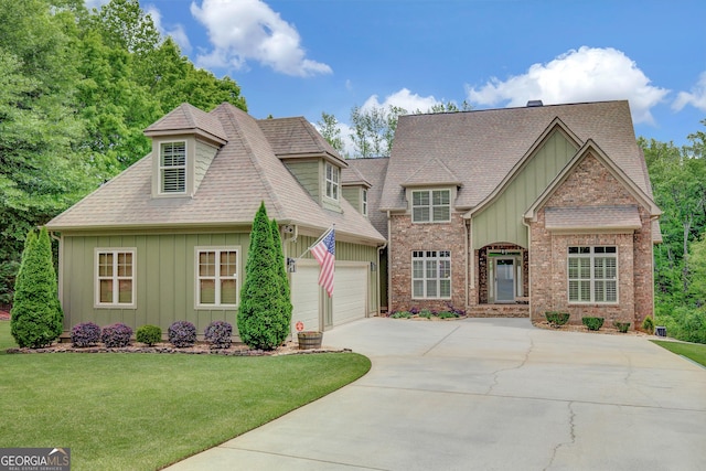 craftsman-style home featuring a front lawn, board and batten siding, roof with shingles, and driveway