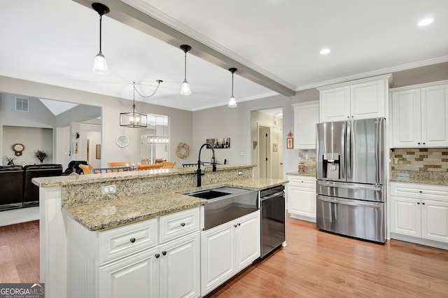 kitchen featuring stainless steel fridge, a sink, black dishwasher, backsplash, and visible vents