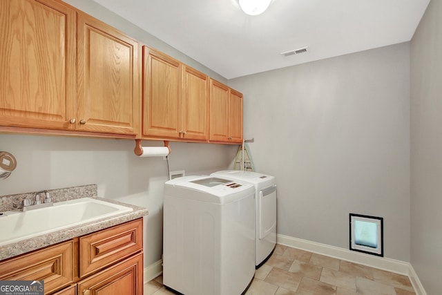 laundry room with cabinet space, a sink, separate washer and dryer, baseboards, and visible vents