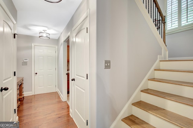stairs featuring wood finished floors