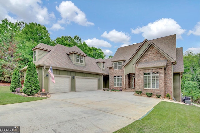 view of front facade with board and batten siding, concrete driveway, and roof with shingles