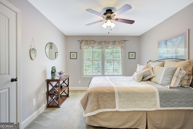 bedroom featuring baseboards, a ceiling fan, and light carpet