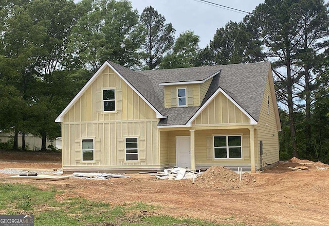 view of front of home with board and batten siding and a shingled roof