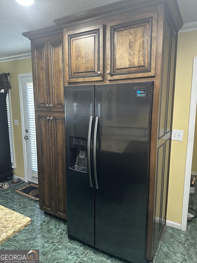 kitchen featuring crown molding, dark brown cabinets, baseboards, a textured ceiling, and refrigerator with ice dispenser