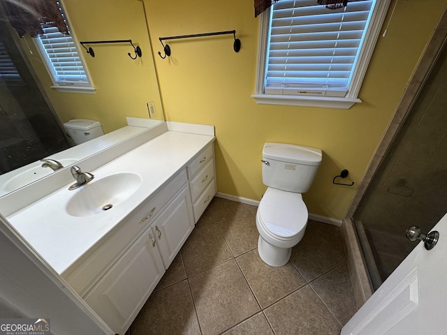 full bath featuring tile patterned flooring, a shower stall, vanity, baseboards, and toilet