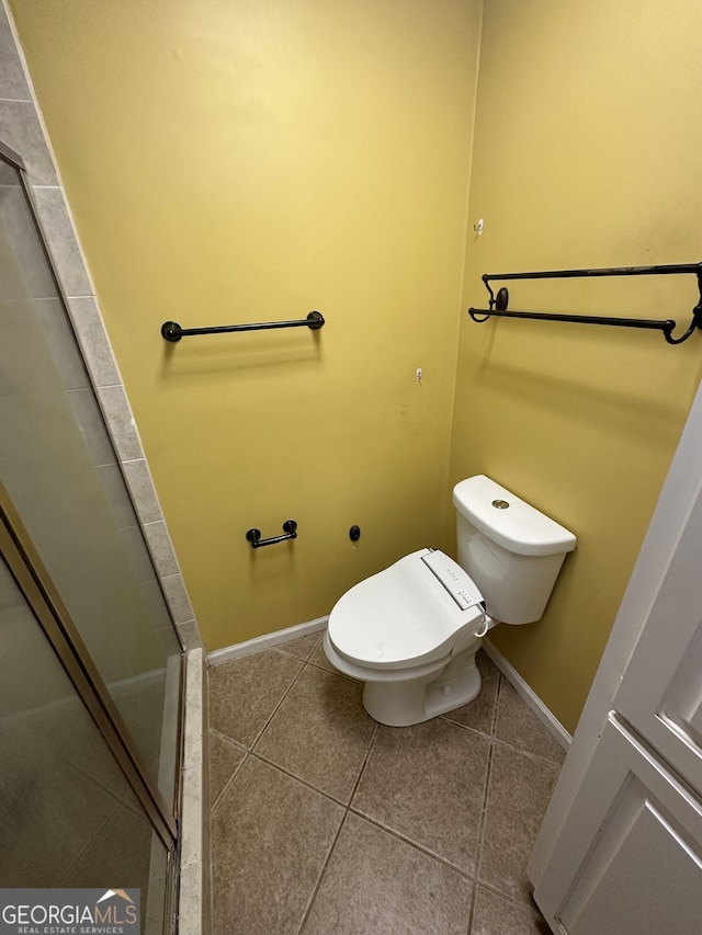 full bathroom with baseboards, an enclosed shower, tile patterned floors, and toilet