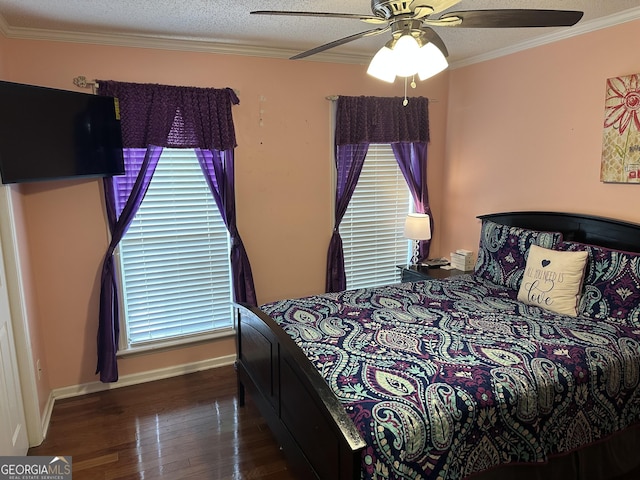 bedroom with baseboards, ornamental molding, a ceiling fan, and wood finished floors