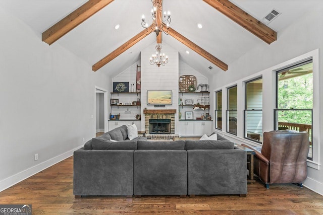 living room featuring baseboards, a fireplace, beam ceiling, and a notable chandelier