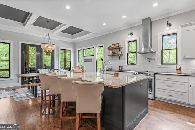 kitchen featuring ornamental molding, electric range, dark wood-style floors, wall chimney exhaust hood, and tasteful backsplash