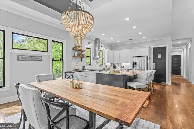 dining room featuring plenty of natural light, ornamental molding, dark wood-type flooring, and a notable chandelier
