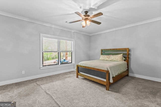 carpeted bedroom with crown molding, baseboards, and ceiling fan