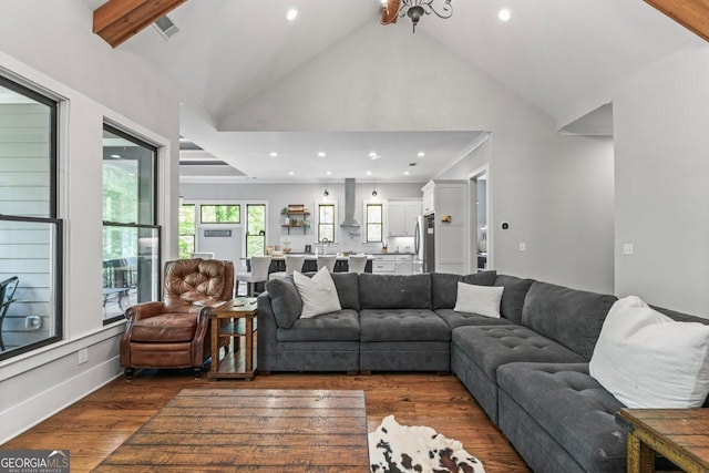 living area with recessed lighting, high vaulted ceiling, and dark wood-style floors