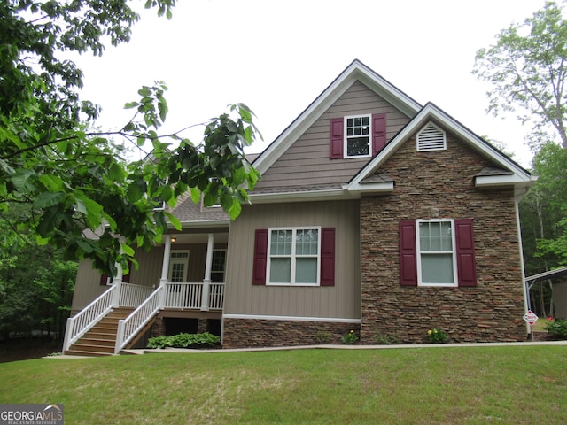 craftsman-style home featuring a front lawn, a porch, stairway, and stone siding