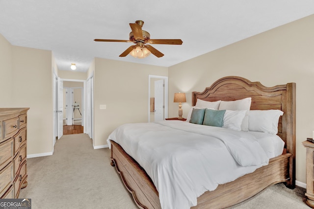 bedroom with baseboards, light carpet, and a ceiling fan