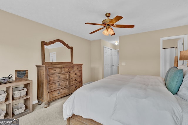 bedroom with light colored carpet, a closet, and a ceiling fan