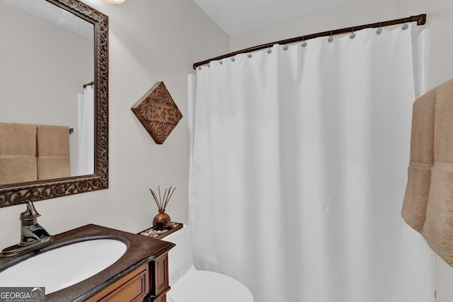 full bathroom with toilet, vanity, and a shower with shower curtain