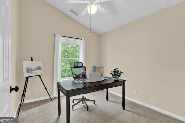 carpeted office featuring lofted ceiling, baseboards, a ceiling fan, and visible vents