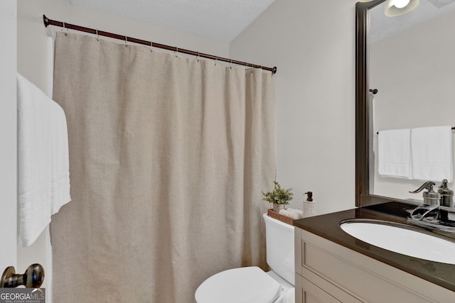 full bathroom with toilet and vanity