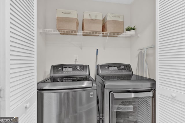 clothes washing area featuring washer and dryer and laundry area