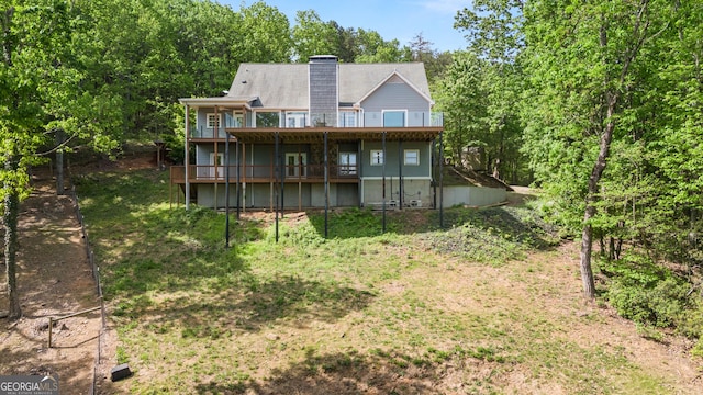 back of property with a deck and a chimney
