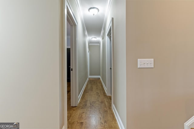 corridor with baseboards and light wood-type flooring