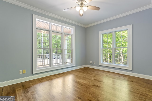 unfurnished room with baseboards, ornamental molding, a ceiling fan, and wood finished floors