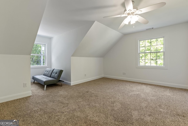 additional living space featuring ceiling fan, carpet floors, baseboards, vaulted ceiling, and visible vents