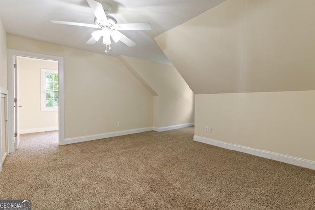 additional living space featuring carpet floors, ceiling fan, baseboards, and lofted ceiling