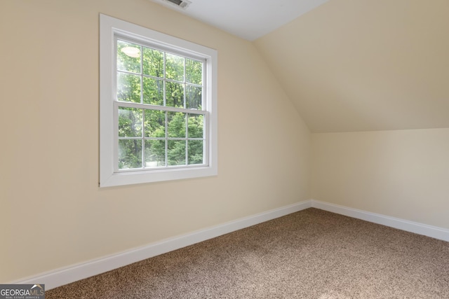 bonus room with plenty of natural light, baseboards, carpet floors, and vaulted ceiling