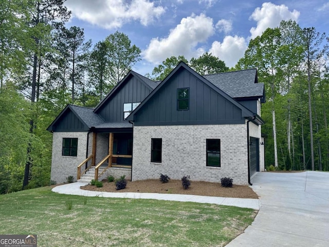modern inspired farmhouse featuring a garage, a front lawn, a shingled roof, board and batten siding, and driveway