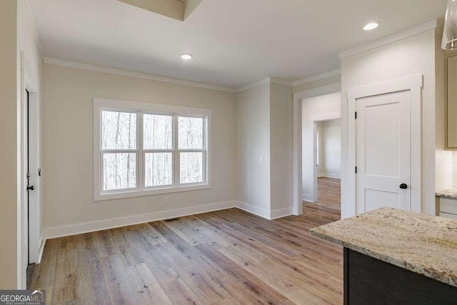 interior space featuring crown molding and baseboards