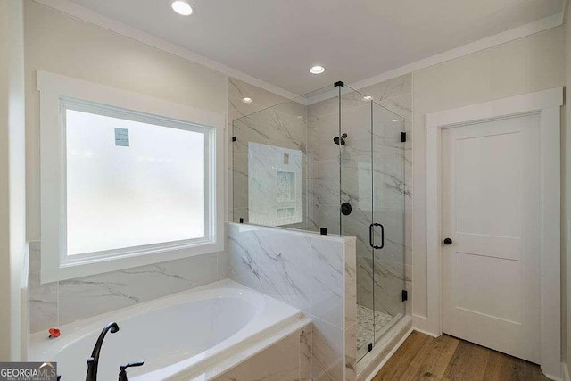 bathroom with recessed lighting, a marble finish shower, a bath, and wood finished floors