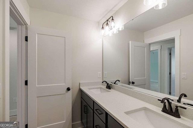 full bathroom with double vanity and a sink