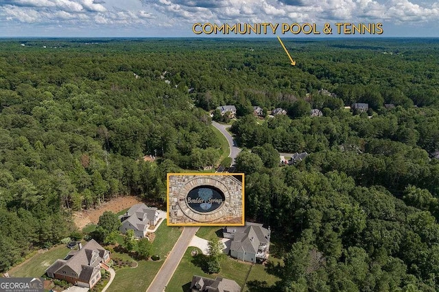 aerial view featuring a wooded view