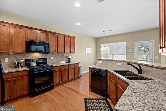 441 Mountain View Ln, Woodstock, GA 30188 - kitchen with a sink, light wood finished floors, black appliances, and decorative backsplash