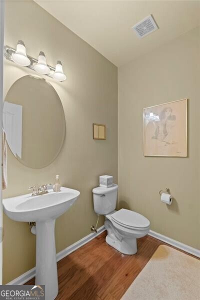 441 Mountain View Ln, Woodstock, GA 30188 - half bath with toilet, baseboards, visible vents, and wood finished floors