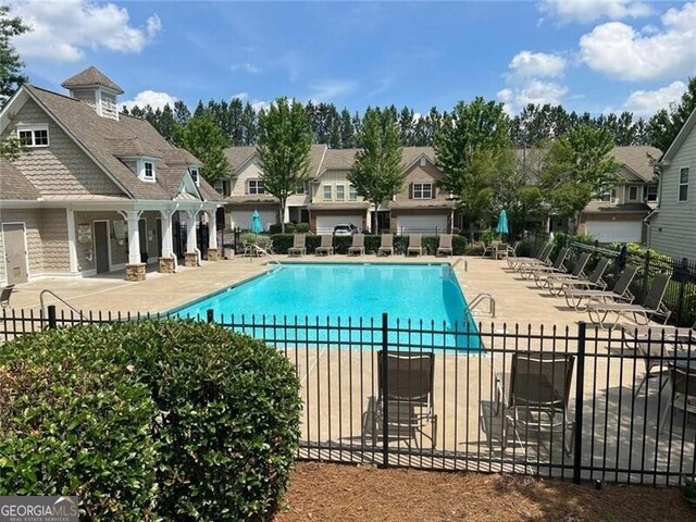 441 Mountain View Ln, Woodstock, GA 30188 - pool with a patio, fence, and a residential view