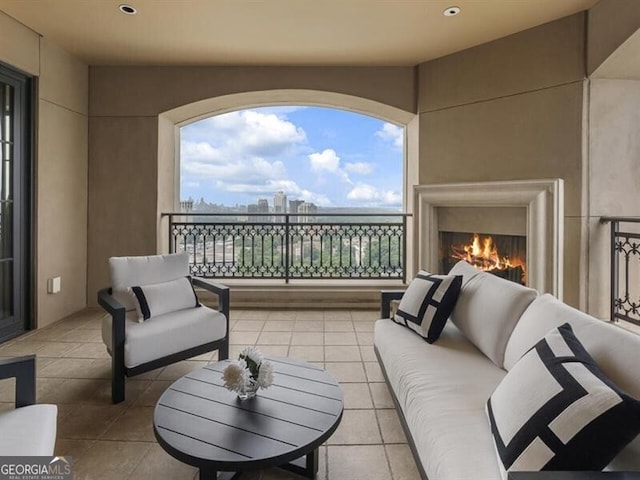 balcony featuring an outdoor living space with a fireplace