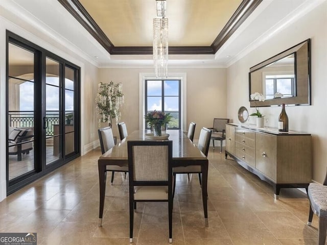 dining space featuring crown molding, a raised ceiling, and tile patterned flooring