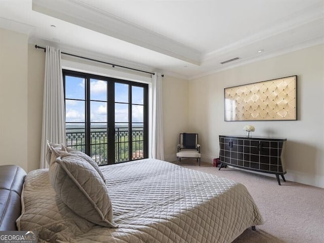 bedroom with carpet flooring, access to outside, a tray ceiling, visible vents, and ornamental molding