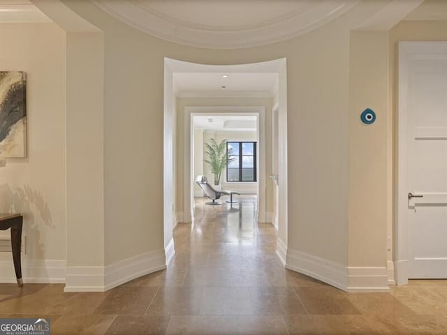 hall with crown molding and baseboards