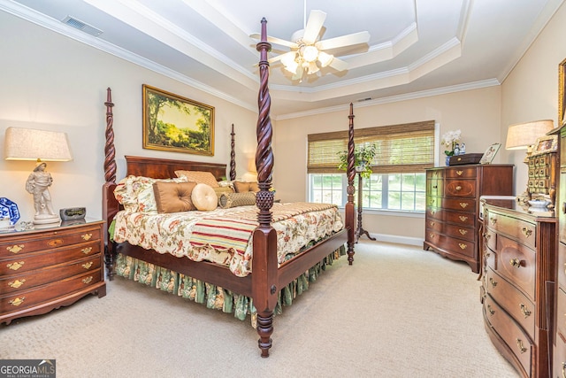 bedroom with light carpet, a raised ceiling, ornamental molding, and a ceiling fan
