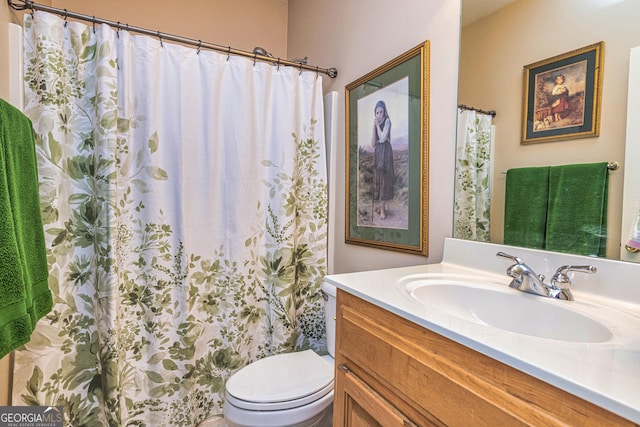 bathroom with toilet, vanity, and a shower with curtain
