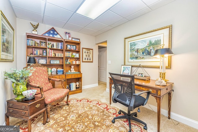 office featuring light colored carpet, baseboards, and a paneled ceiling