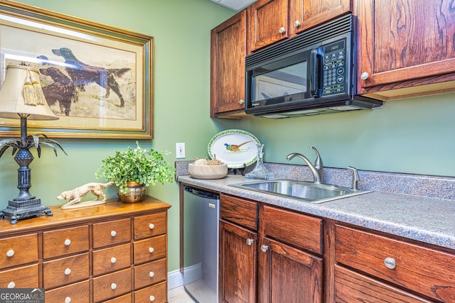 kitchen with black microwave, a sink, dishwashing machine, and light countertops